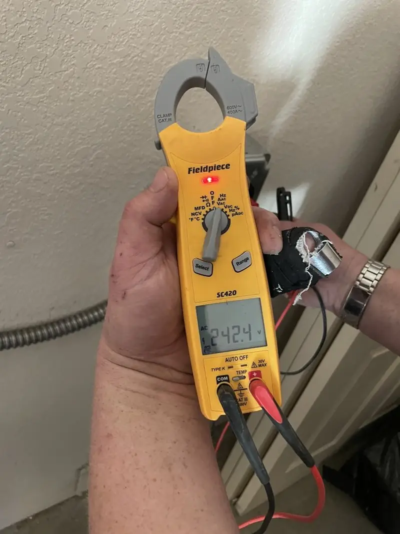 Voltage testing with clamp meter during Outlet Installation in Arnold